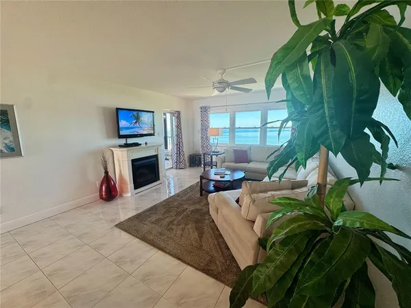 a living room with furniture a rug and a chandelier