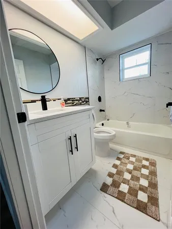 a bathroom with a sink a toilet and a mirror