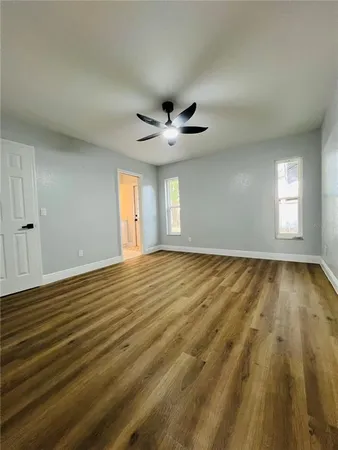 wooden floor in an empty room with a window