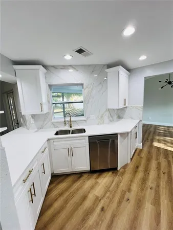a kitchen with stainless steel appliances granite countertop a sink and stove