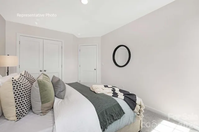 a bedroom with a bed and a potted plant