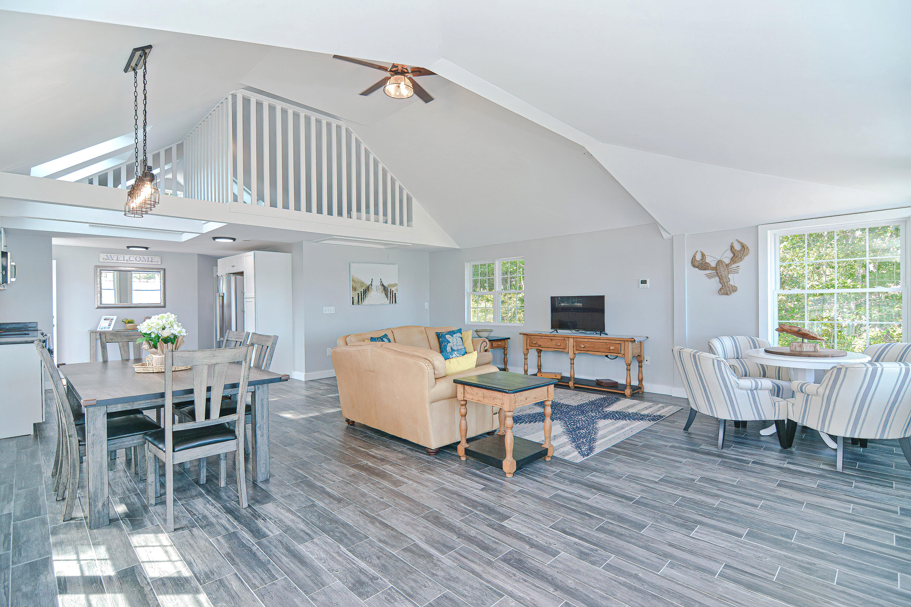 12-13 Shell Lane Wareham, MA 02571 - Photo 36 of 52 a living room with furniture a wooden floor and a window