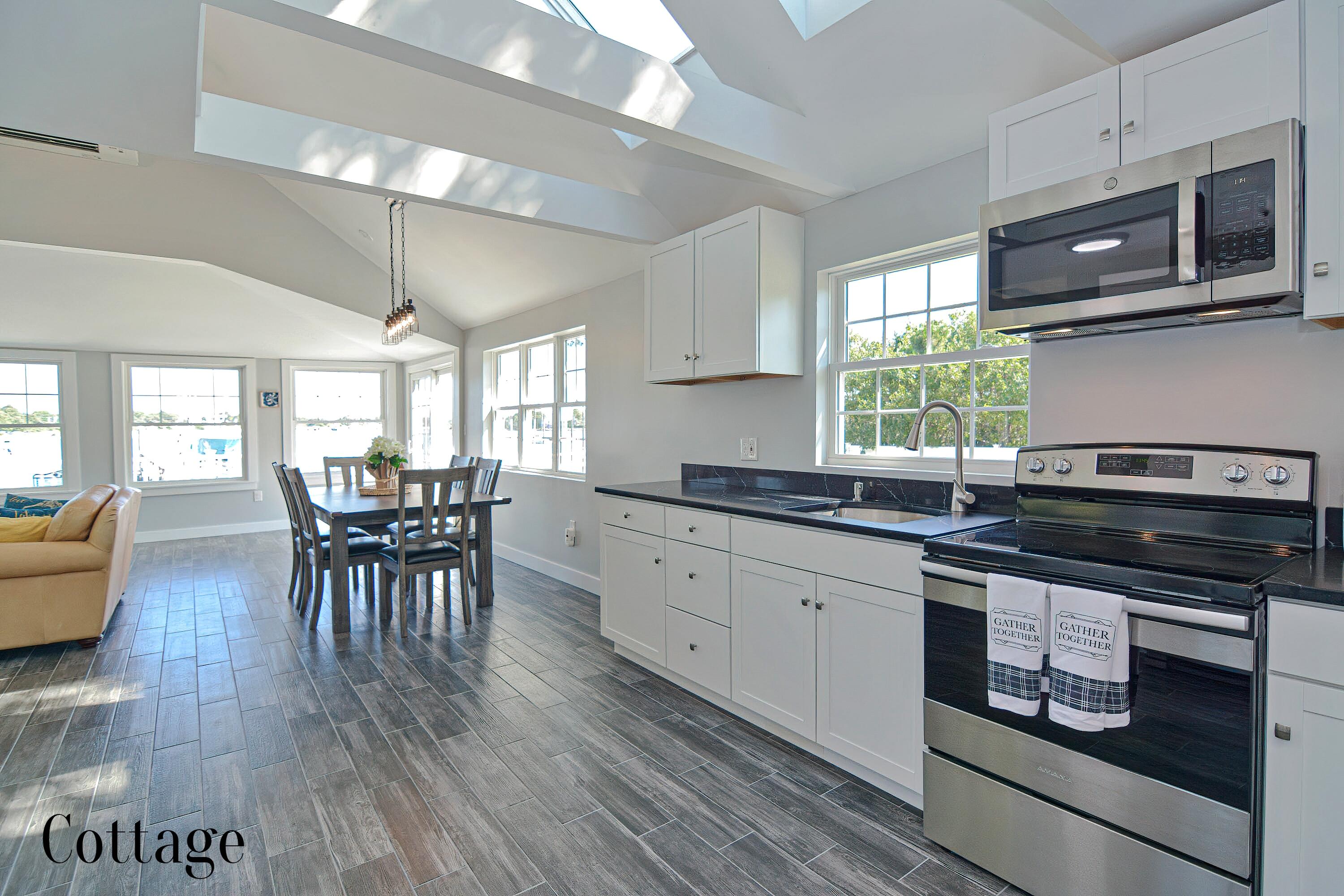 12-13 Shell Lane Wareham, MA 02571 - Photo 38 of 52 a kitchen with stainless steel appliances wooden floors stove dining table and chairs