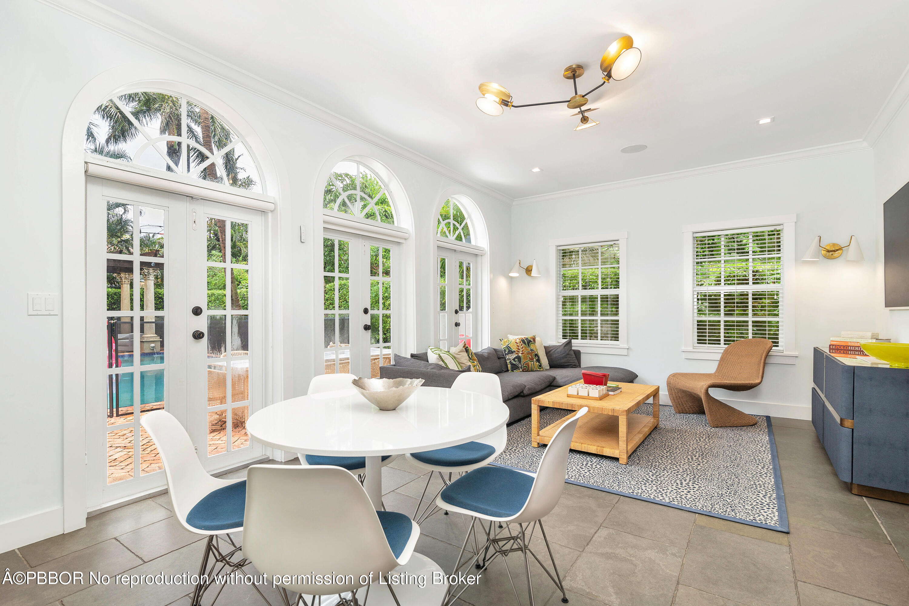 231 Sunset Road West Palm Beach, FL 33401 - Photo 8 of 22 a living room with furniture chandelier and a large window