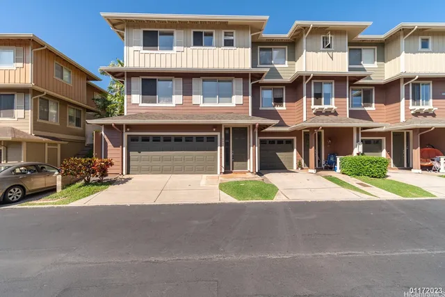 a front view of a brick house with a yard