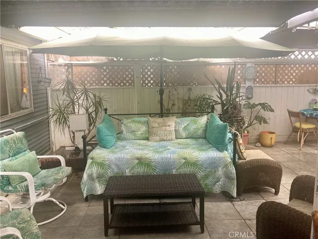 a balcony with furniture and a floor to ceiling window