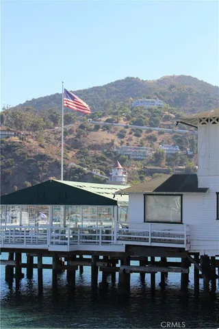 a roof deck with table and chairs