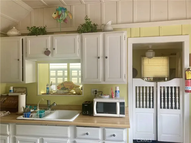 a kitchen with a stove and a white cabinet