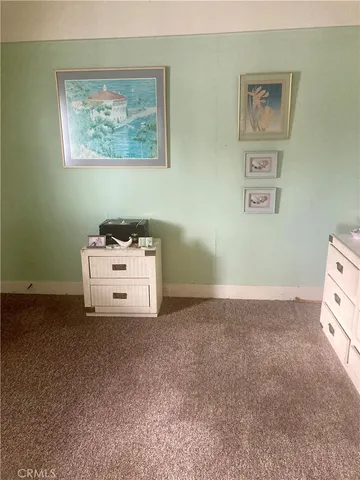 a room with a bed and wall painting