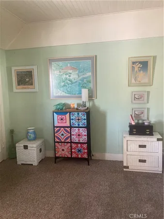 a bedroom with a bed and a cabinet