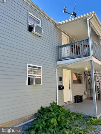 a front view of a house with white walls