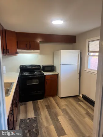 a kitchen with a refrigerator sink and stove