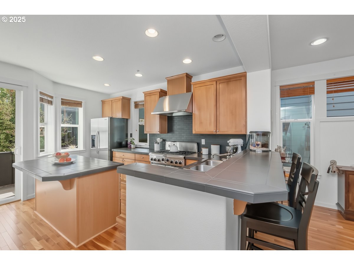 8810 Southeast 12th Avenue Portland, OR 97202 - Photo 13 of 47 a kitchen with counter top space a sink cabinets and appliances
