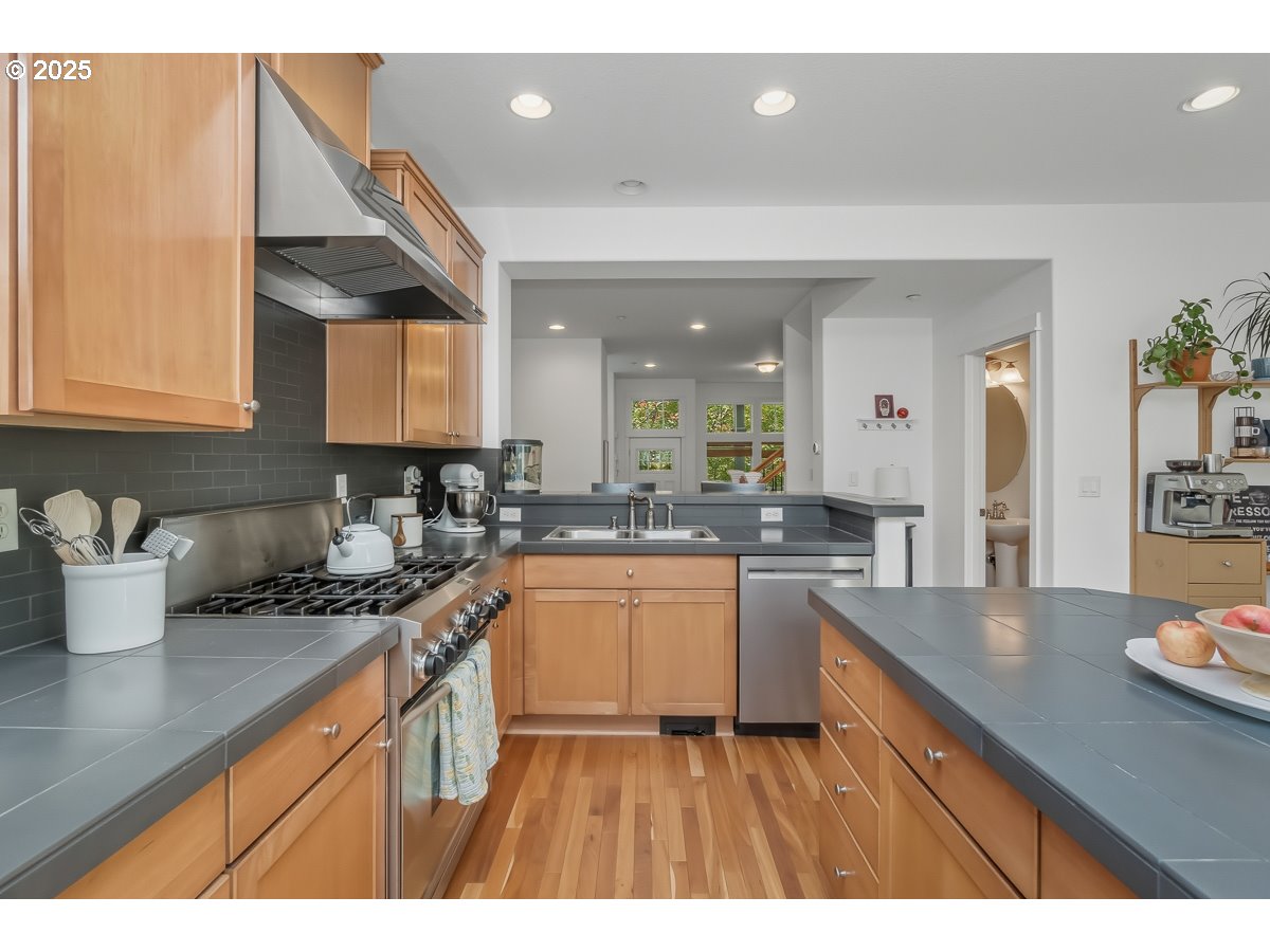 8810 Southeast 12th Avenue Portland, OR 97202 - Photo 17 of 47 a kitchen with sink a stove and cabinets