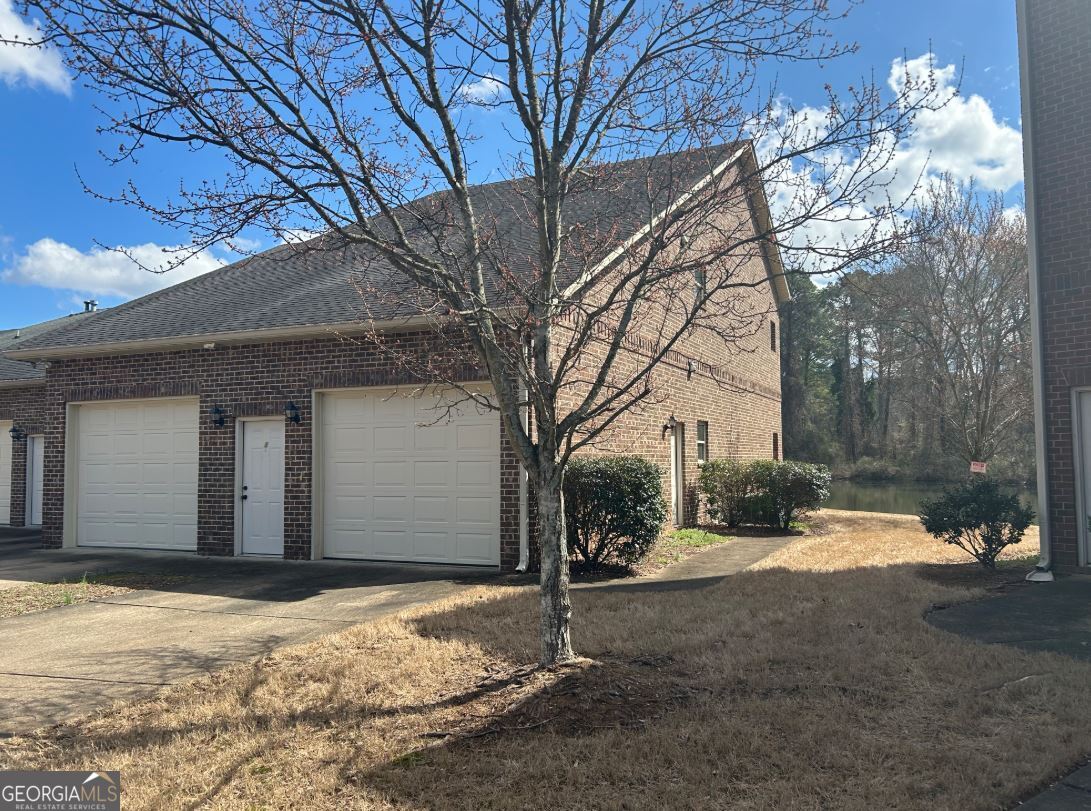 a view of a house with a yard covered in snow