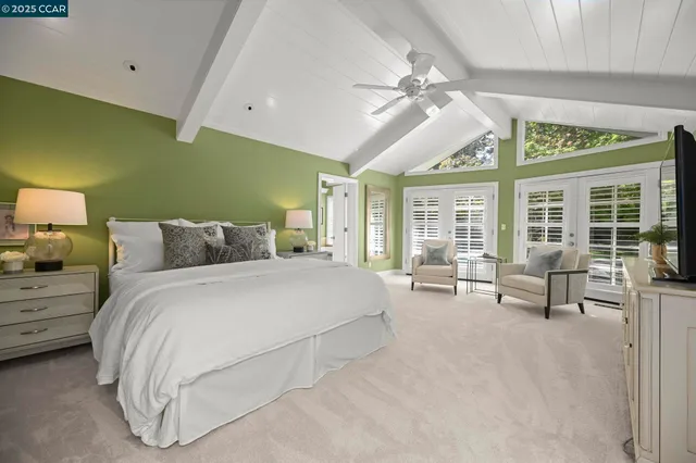 a bedroom with bed and large window