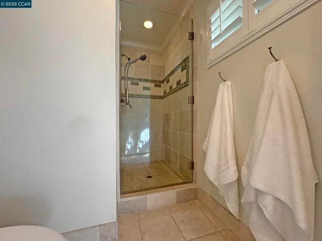 a bathroom with a granite countertop shower a toilet and a sink