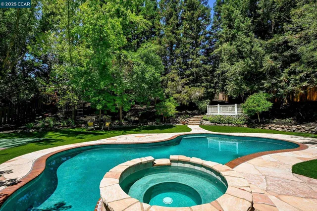 a swimming pool with trees in the background