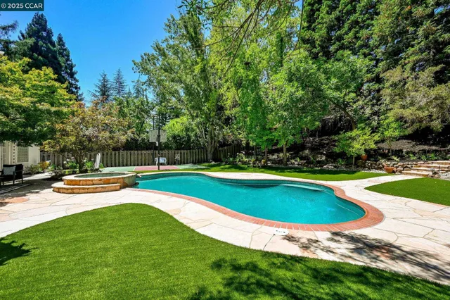 a view of swimming pool with lounge chair