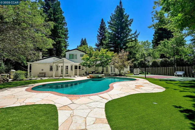 a view of a house with a yard and a patio