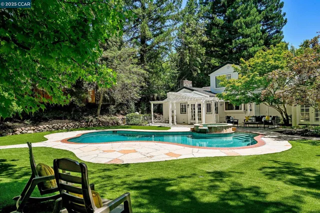 a view of a house with swimming pool and sitting area
