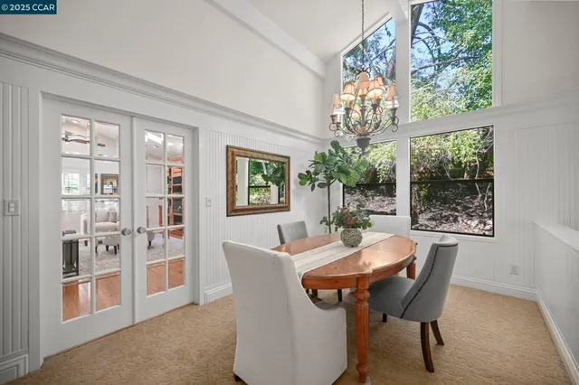 a dining room with furniture a livingroom view and outdoor space