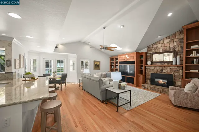 a living room with fireplace furniture and a wooden floor