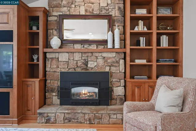 a living room with a fireplace and a fireplace