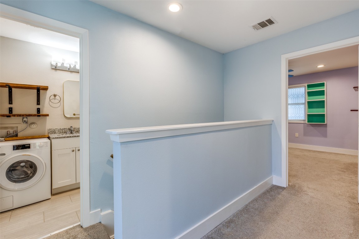 935 La Posada Drive, Unit 155 Austin, TX 78752 - Photo 13 of 25 Laundry area with washer / clothes dryer, recessed lighting, and light carpet