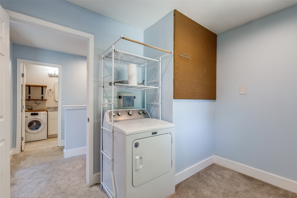 935 La Posada Drive, Unit 155 Austin, TX 78752 - Photo 14 of 25 Laundry room featuring washer / clothes dryer and light carpet