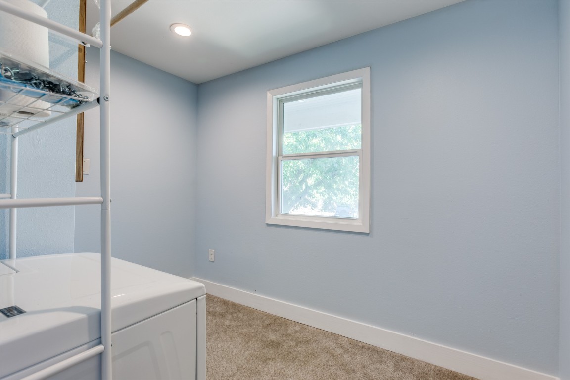 935 La Posada Drive, Unit 155 Austin, TX 78752 - Photo 15 of 25 Laundry area with light carpet and baseboards