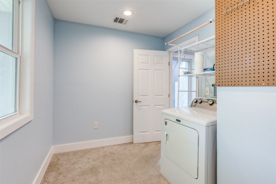 935 La Posada Drive, Unit 155 Austin, TX 78752 - Photo 16 of 25 Laundry area with washer / clothes dryer and light carpet