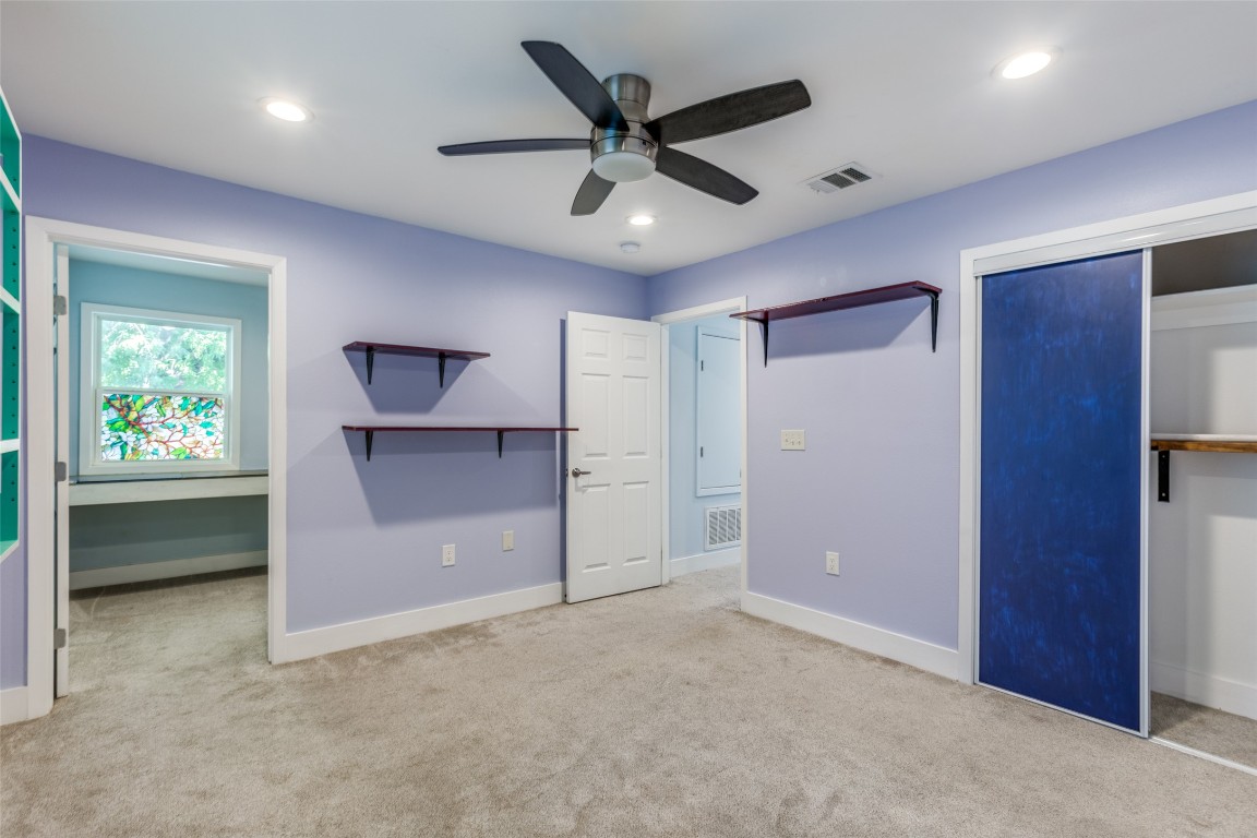 935 La Posada Drive, Unit 155 Austin, TX 78752 - Photo 22 of 25 Unfurnished bedroom with light colored carpet, a closet, ceiling fan, and recessed lighting