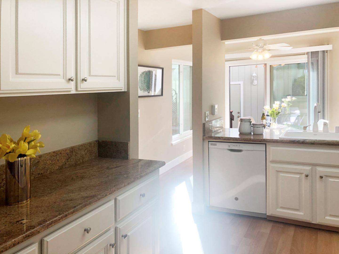 213 Ortega Avenue Mountain View, CA 94040 - Photo 11 of 37 a kitchen with granite countertop white cabinets and white appliances