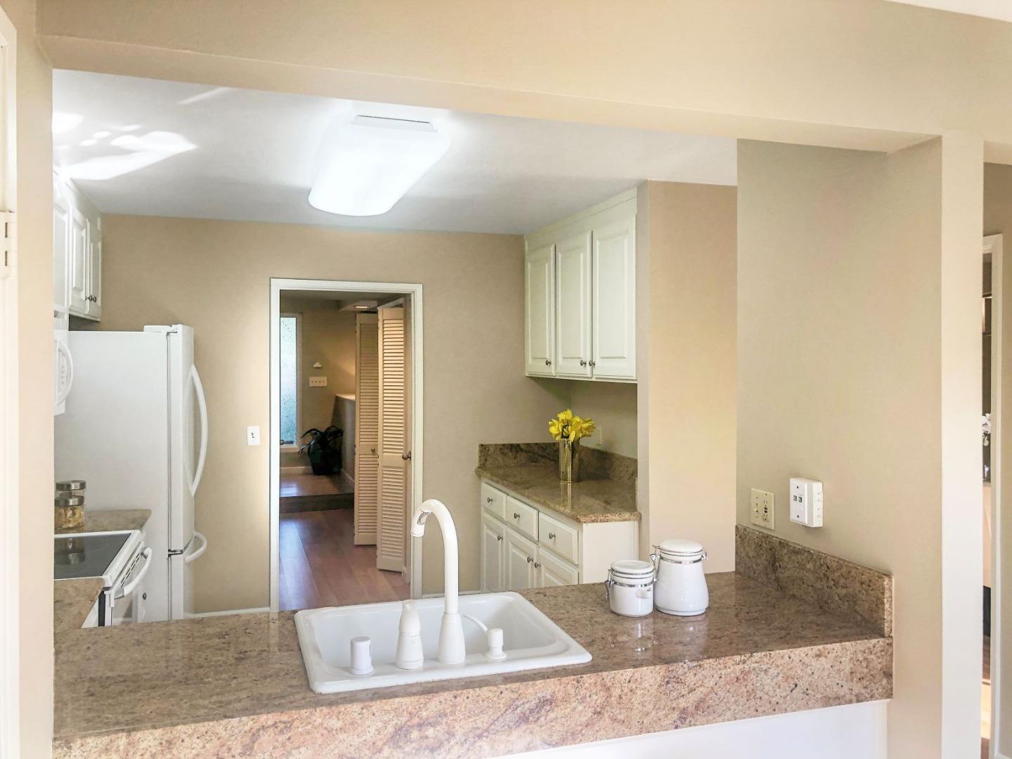 213 Ortega Avenue Mountain View, CA 94040 - Photo 12 of 37 a kitchen with granite countertop a view of living room and wooden floor