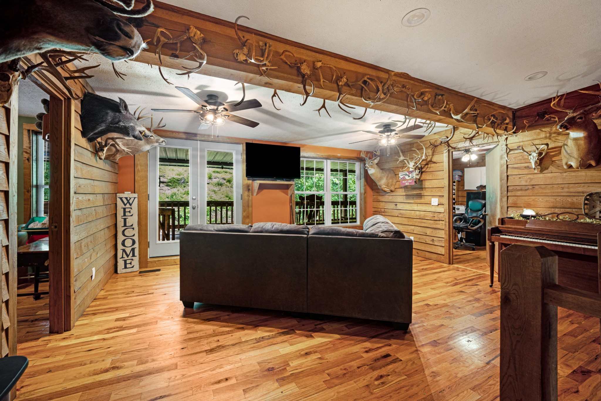715 Rogues Fork Road Bethpage, TN 37022 - Photo 15 of 68 a living room with couches and kitchen view with wooden floor