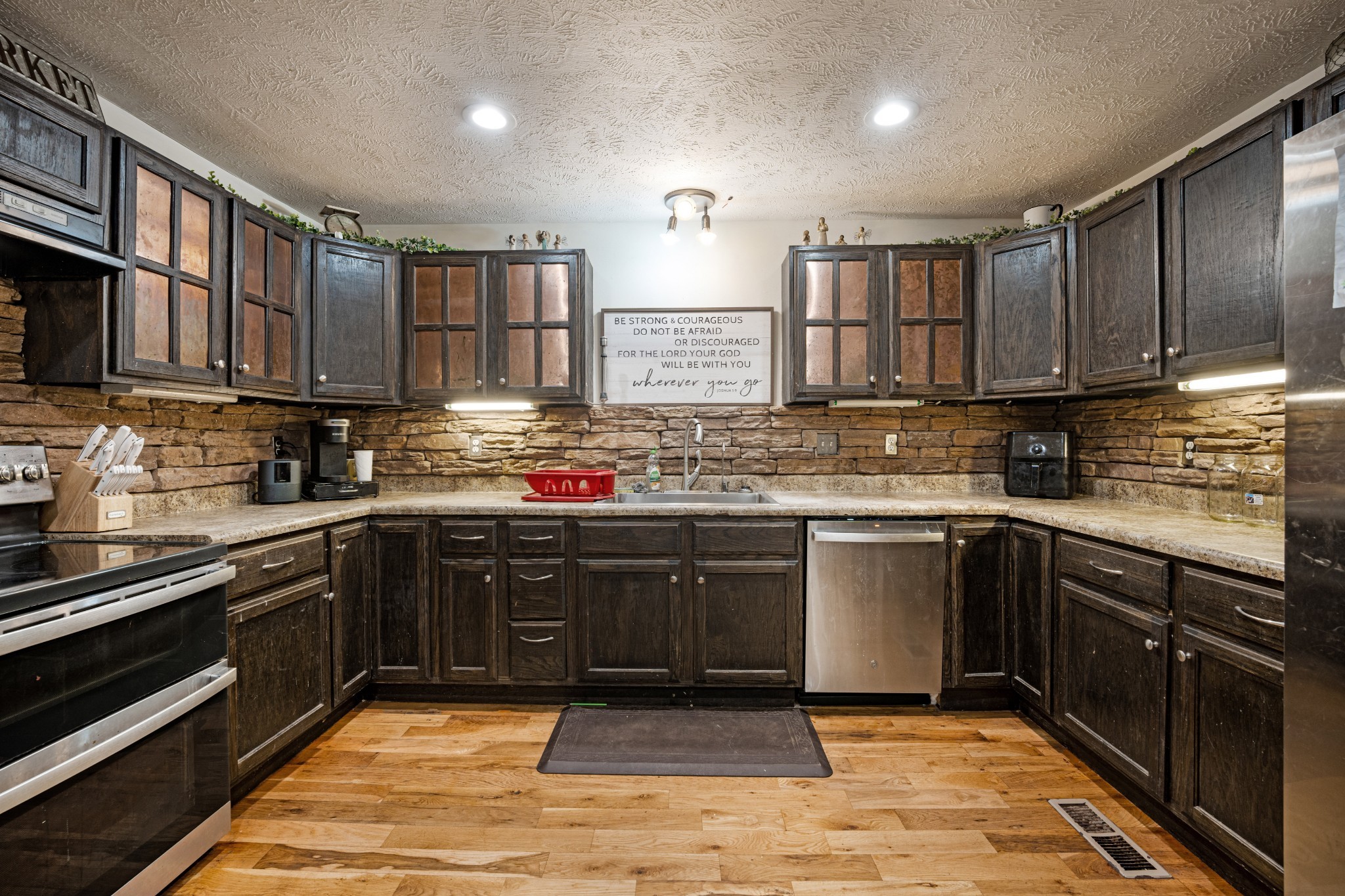 715 Rogues Fork Road Bethpage, TN 37022 - Photo 10 of 68 a kitchen with stainless steel appliances granite countertop a stove sink cabinets and window