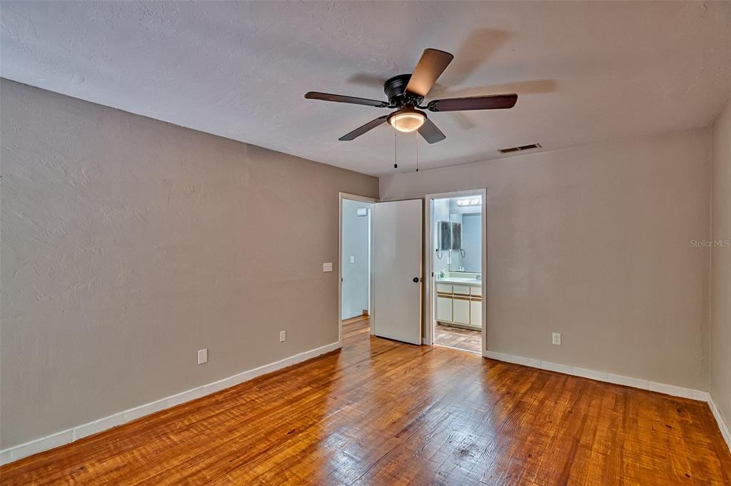 5422 Southwest 4th Place Gainesville, FL 32607 - Photo 19 of 29 a view of empty room with wooden floor and fan