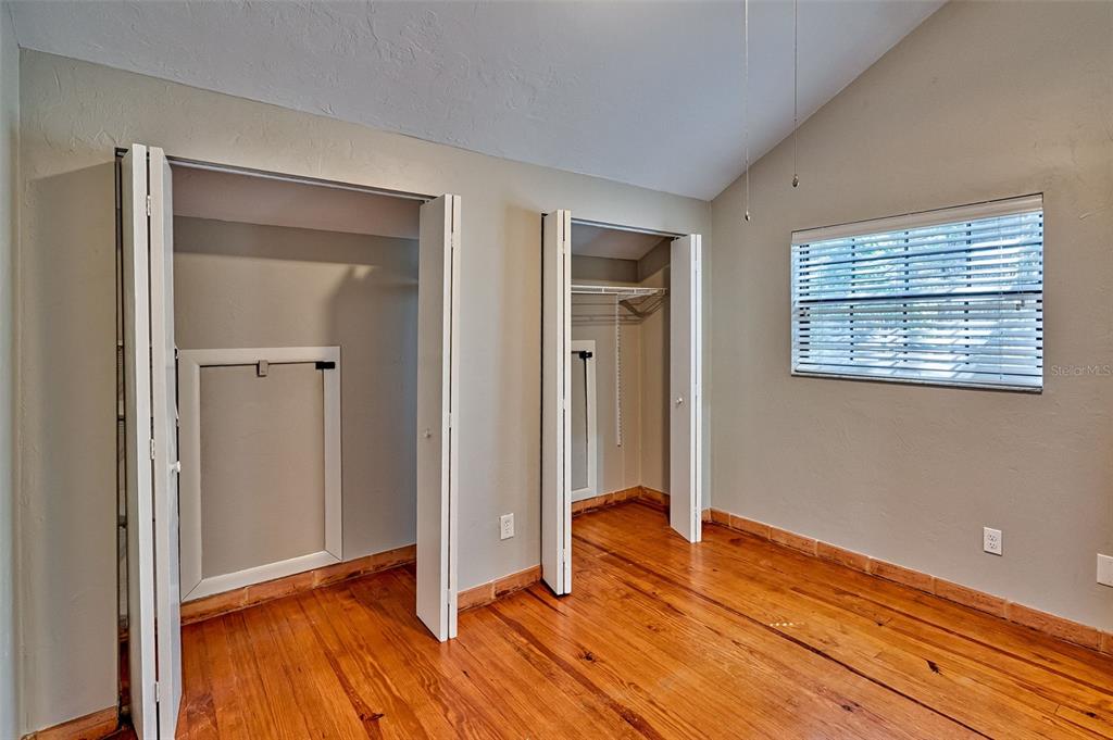 5422 Southwest 4th Place Gainesville, FL 32607 - Photo 24 of 29 an empty room with wooden floor and windows