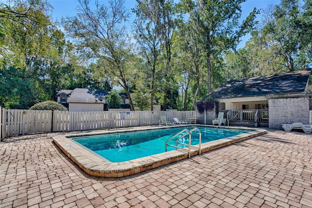 5422 Southwest 4th Place Gainesville, FL 32607 - Photo 28 of 29 a view of a backyard with a large tree and wooden fence
