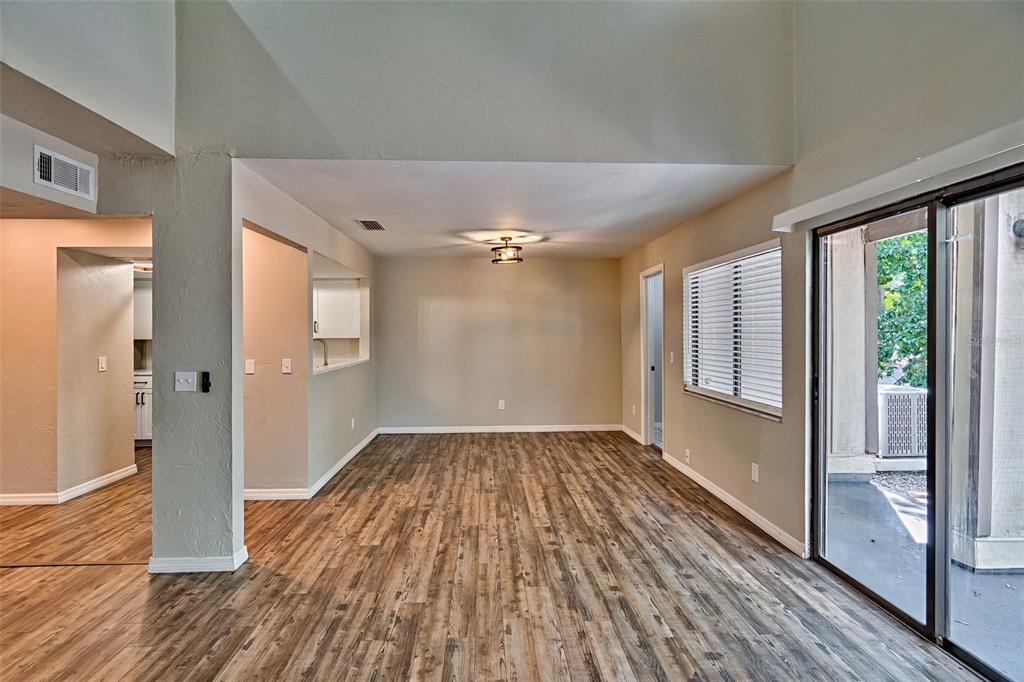 5422 Southwest 4th Place Gainesville, FL 32607 - Photo 10 of 29 a view of empty room with wooden floor and fan