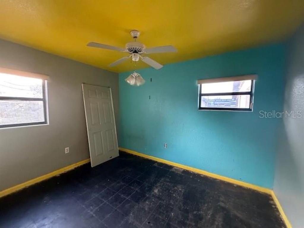 701 Madison Street Tavares, FL 32778 - Photo 8 of 12 a view of room with window and ceiling fan