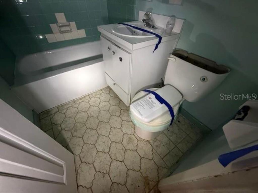 701 Madison Street Tavares, FL 32778 - Photo 10 of 12 a bathroom with a sink and a mirror