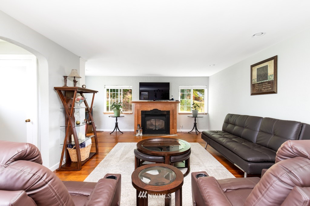 16722 Blodgett Road Mount Vernon, WA 98274 - Photo 17 of 37 a living room with furniture a flat screen tv and a fireplace