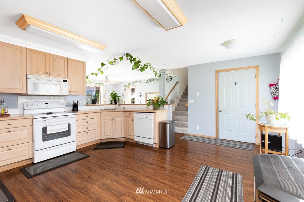 16722 Blodgett Road Mount Vernon, WA 98274 - Photo 23 of 37 a kitchen with wooden floors and white appliances