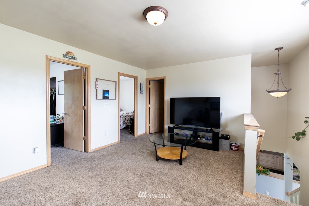 16722 Blodgett Road Mount Vernon, WA 98274 - Photo 29 of 37 a living room with furniture and a flat screen tv
