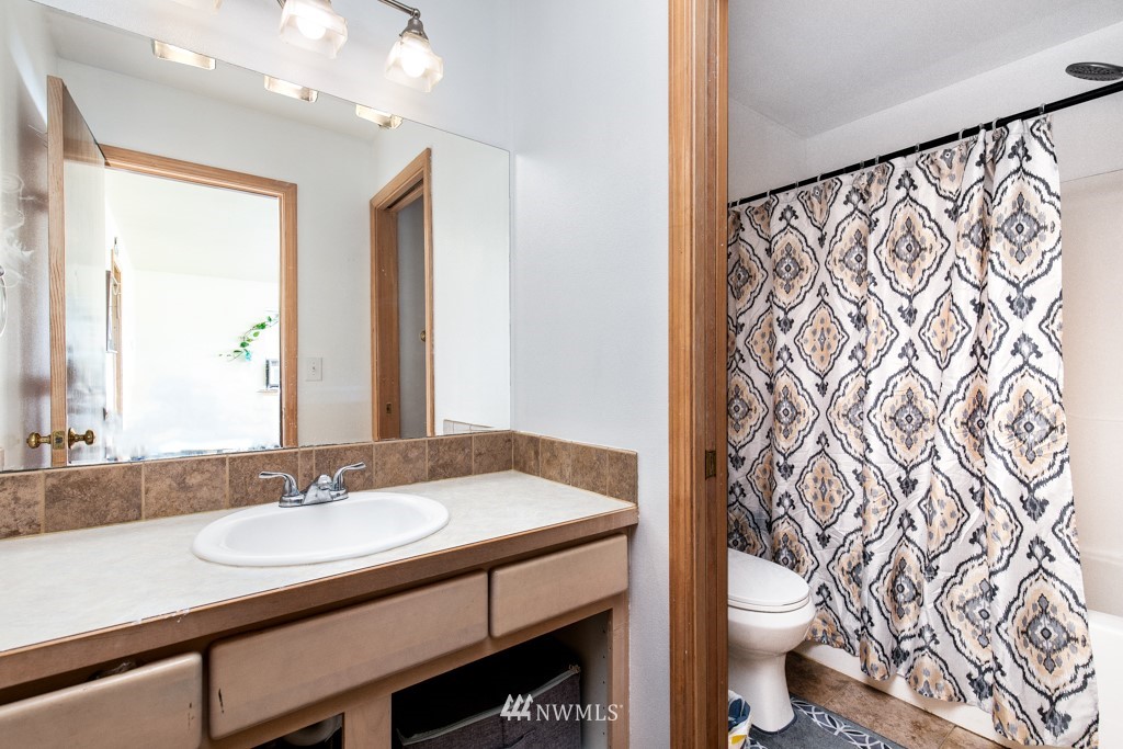 16722 Blodgett Road Mount Vernon, WA 98274 - Photo 32 of 37 a bathroom with a sink a toilet and a mirror