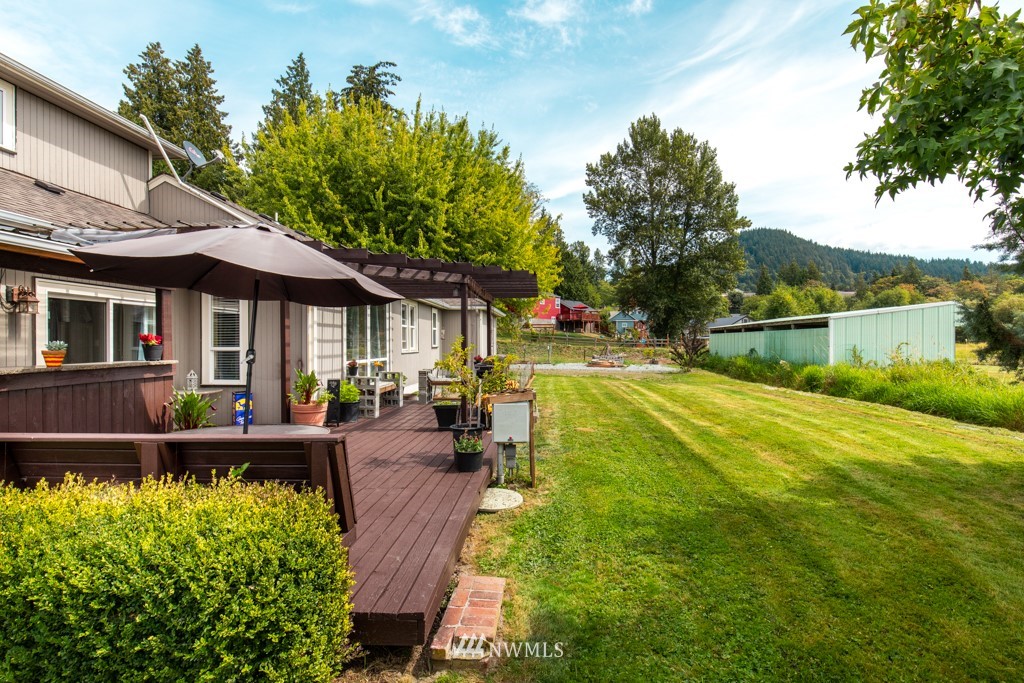16722 Blodgett Road Mount Vernon, WA 98274 - Photo 10 of 37 a view of patio with table and chairs potted plants and large tree