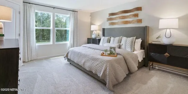 a bedroom with a bed and window