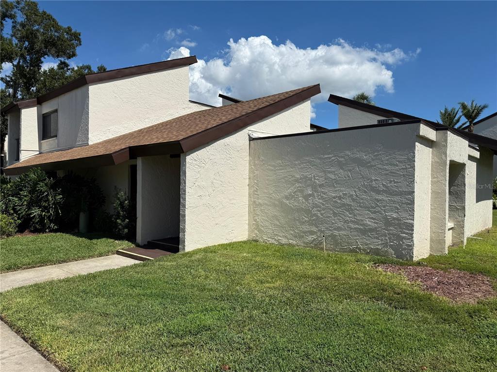2207 Belleair Road, Unit B22 Clearwater, FL 33764 - Photo 1 of 17 a front view of house with yard